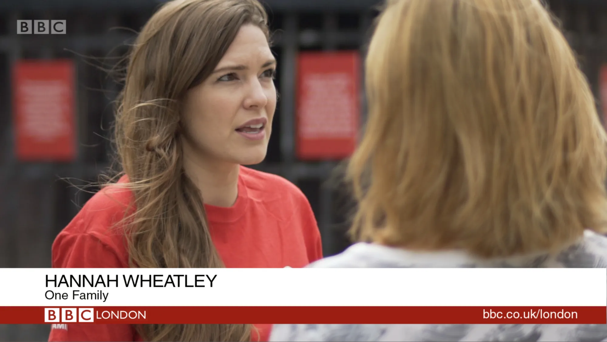 A BBC London news interview with a One Family representative in a red T-shirt