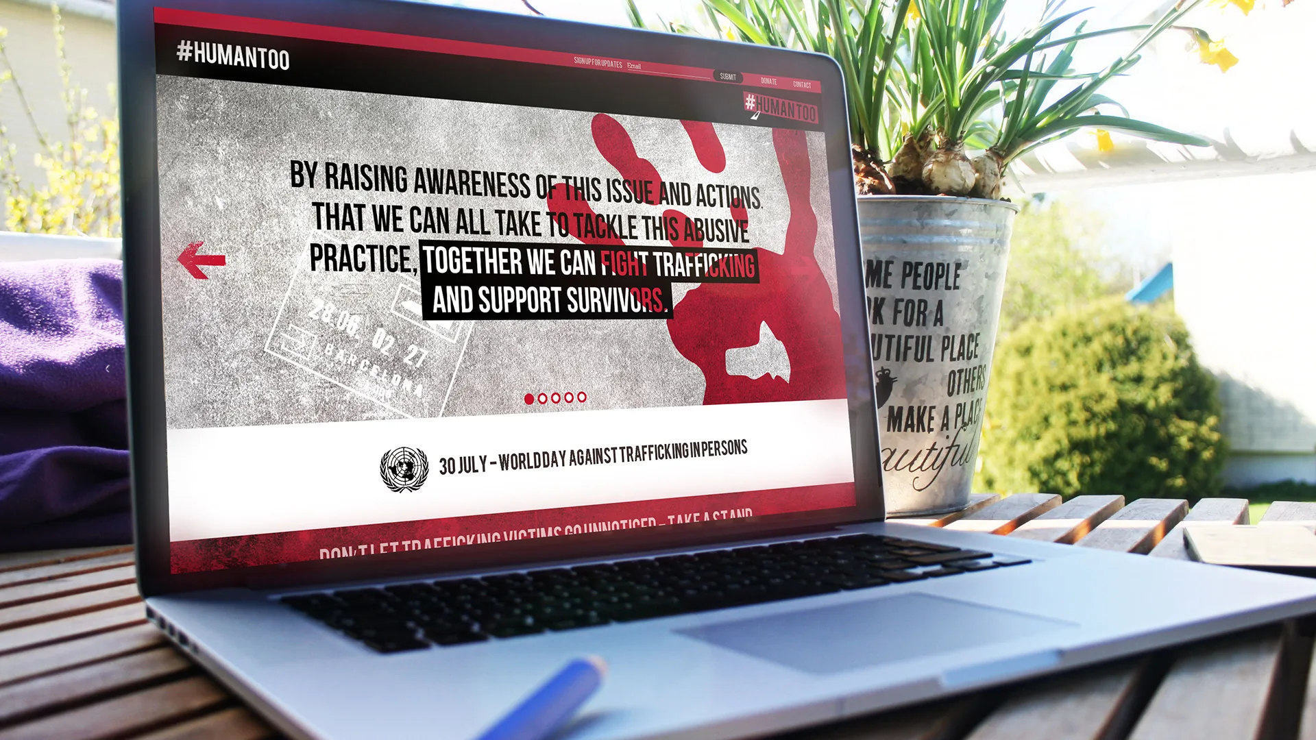 The #HUMANTOO campaign web page on a laptop, marking World Day Against Trafficking in Persons on 30 July