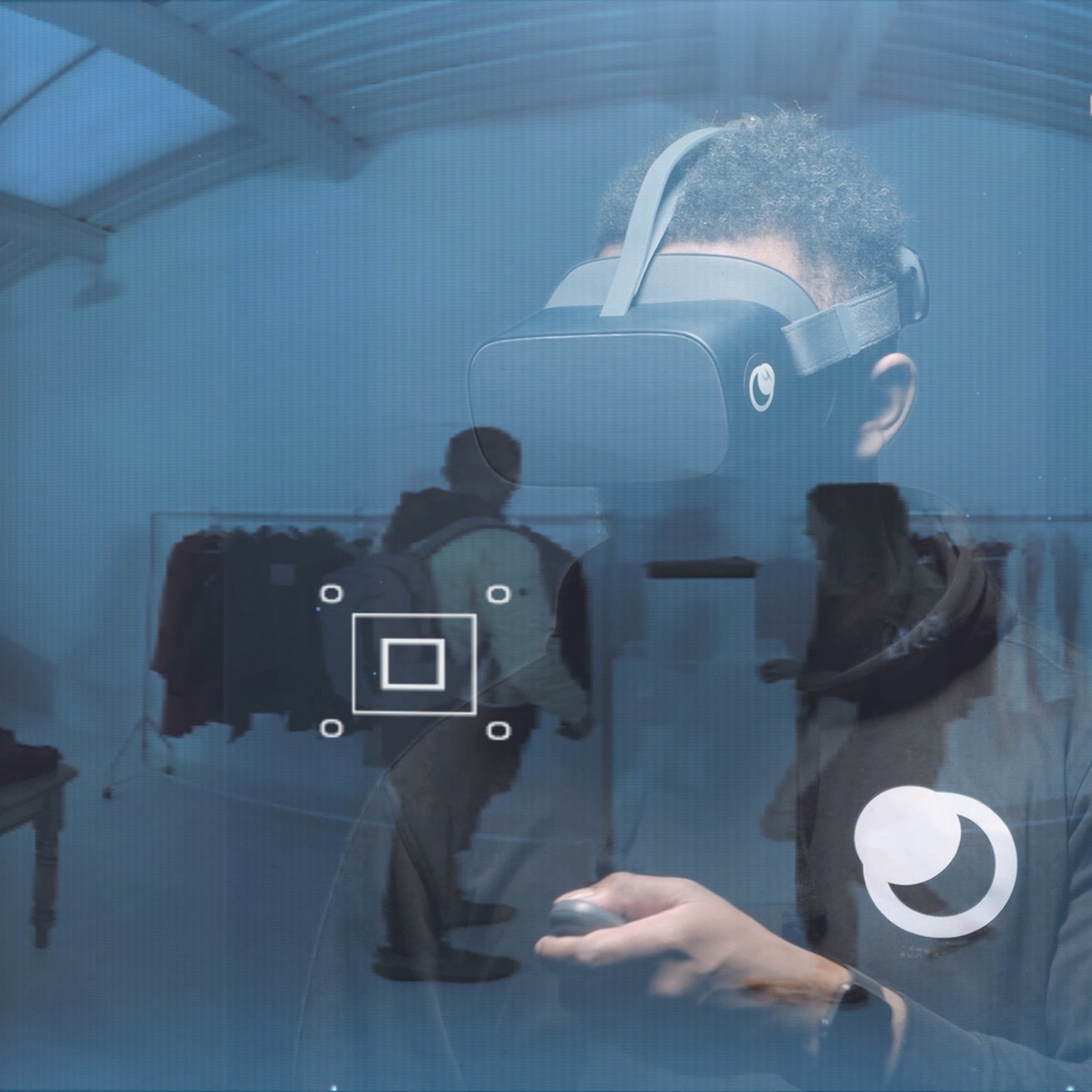 Brand film still in blue: a trainee in a VR headset seen through a holographic interface with a target marker and the Moonhub icon