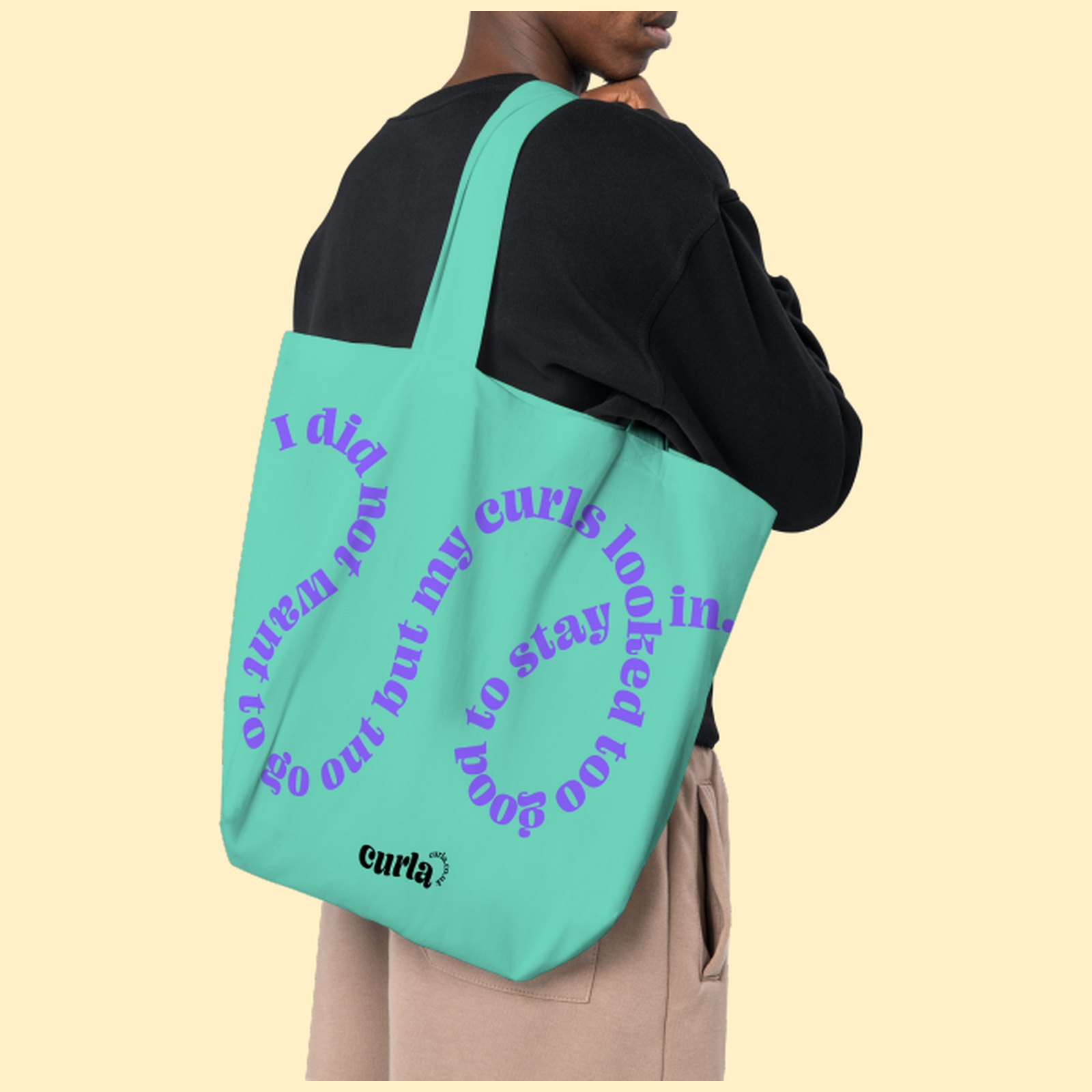 A mint Curla tote bag printed with a violet spiral of text reading I did not want to go out but my curls looked too good to stay in