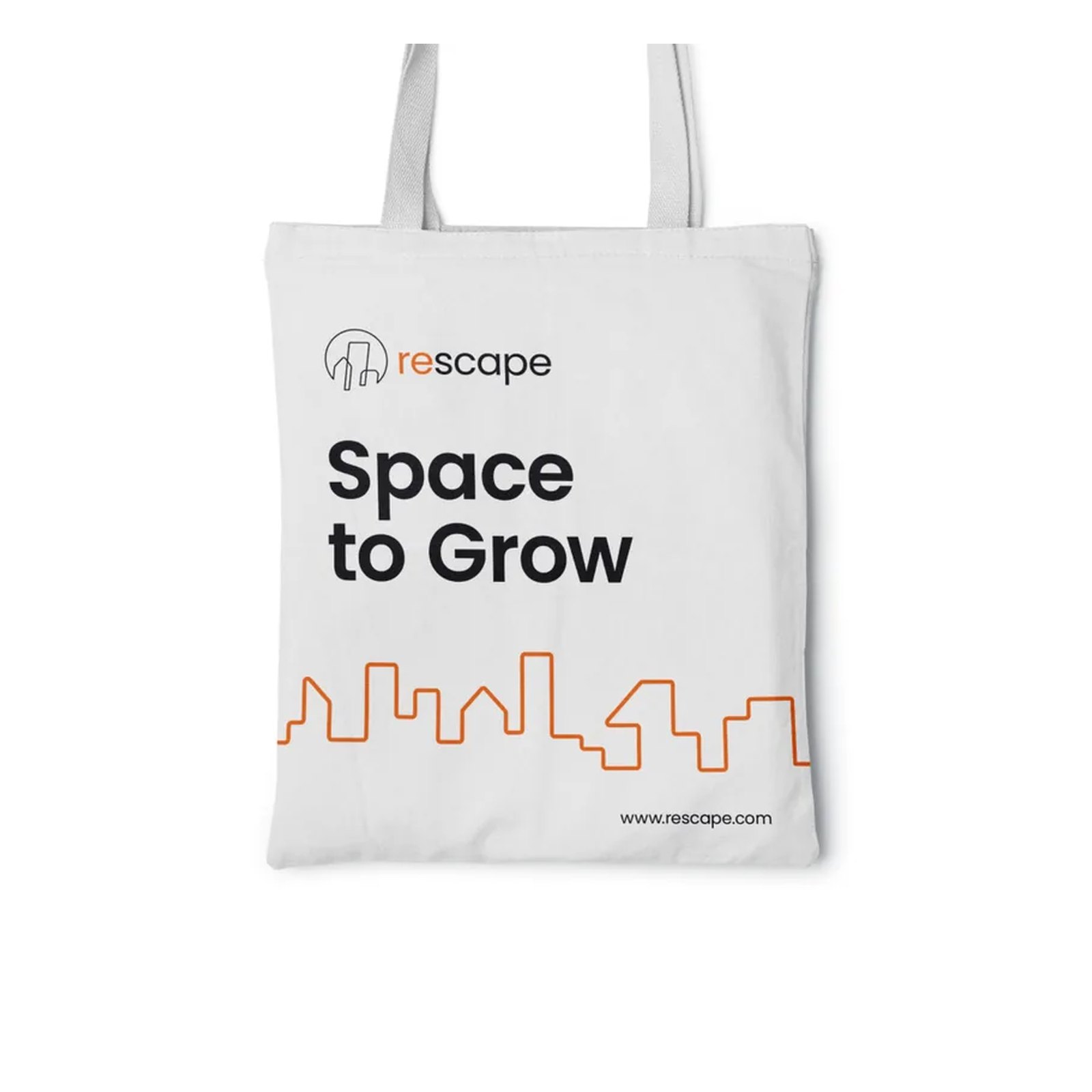 A white Rescape tote bag reading Space to Grow, with the orange skyline line running along the bottom