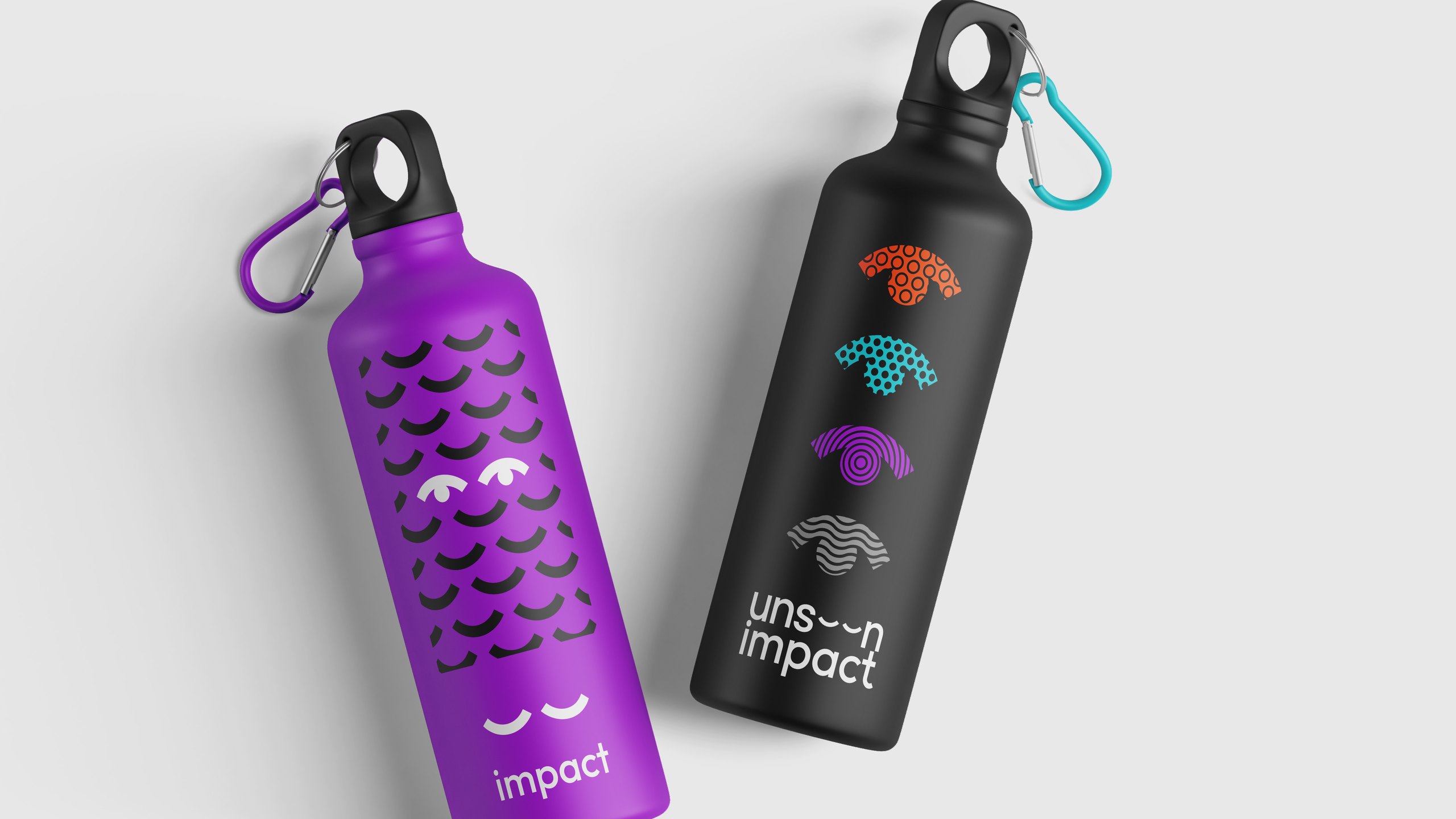 Two water bottles seen from above: a purple bottle with a pattern of closed eyes and the word impact, and a black bottle with four patterned eye shapes and the unseen impact wordmark