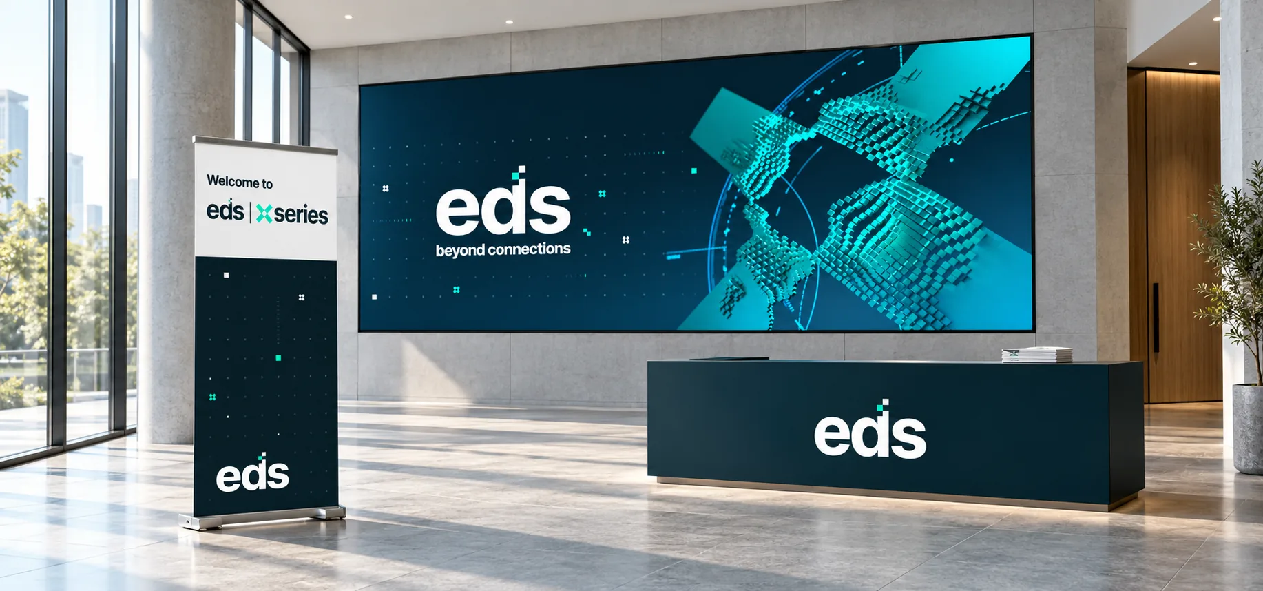 An EDS reception with a large screen showing the logo and pixel X, a branded desk and an eds xseries roller banner