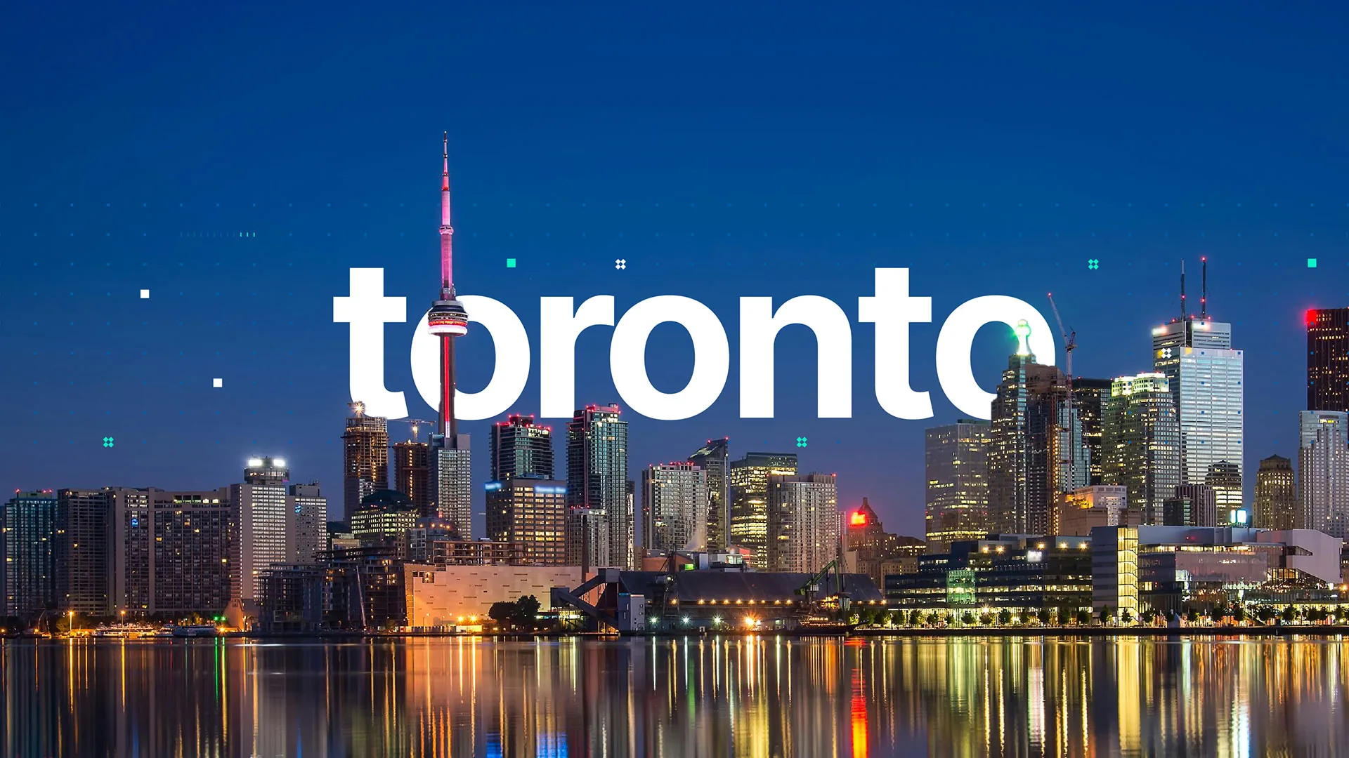 Toronto in large white letters over the city skyline at night, with the CN Tower