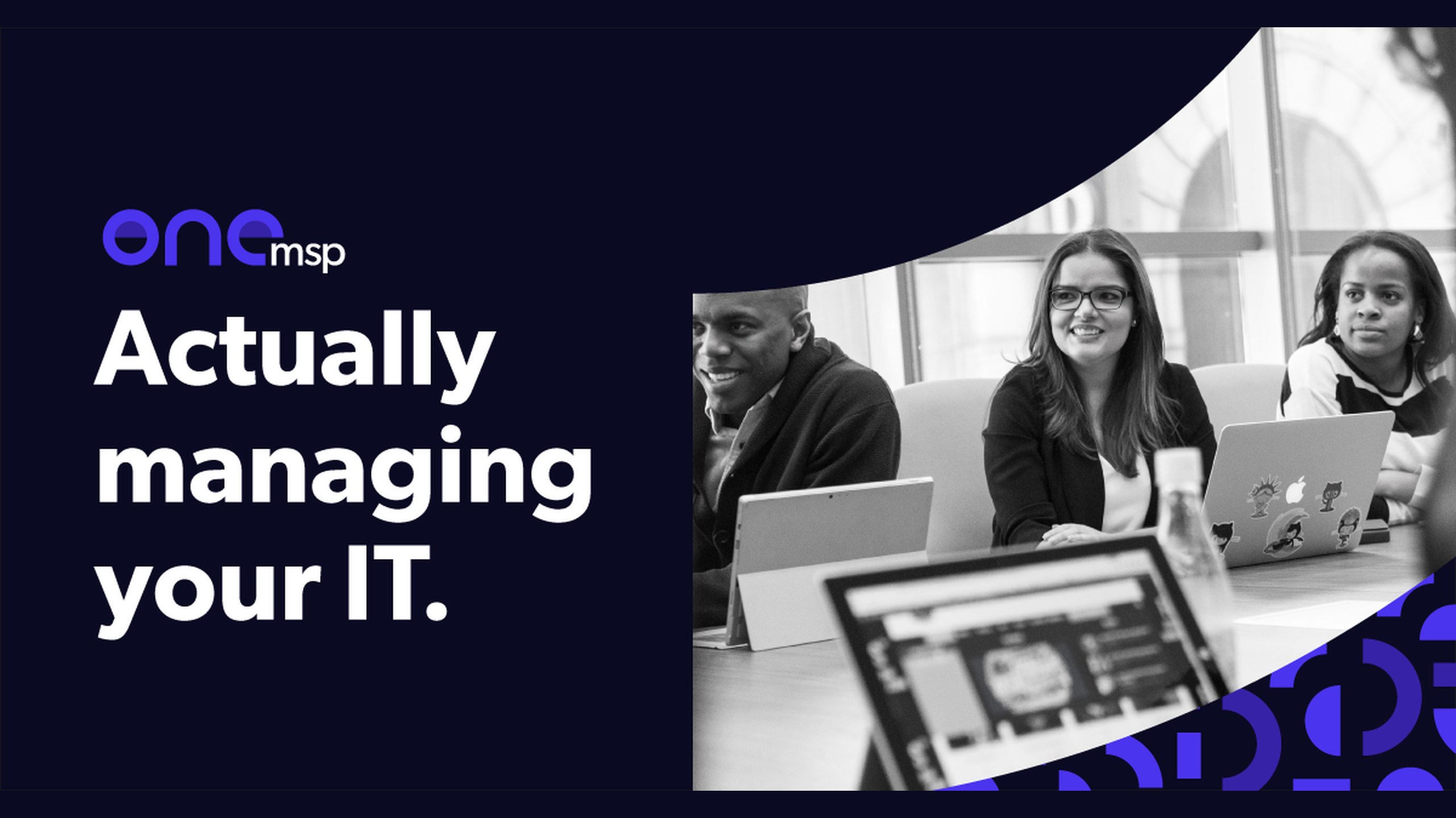OneMSP web banner reading Actually managing your IT. beside a black and white photo of colleagues at their laptops, framed by the brand’s blue arc pattern