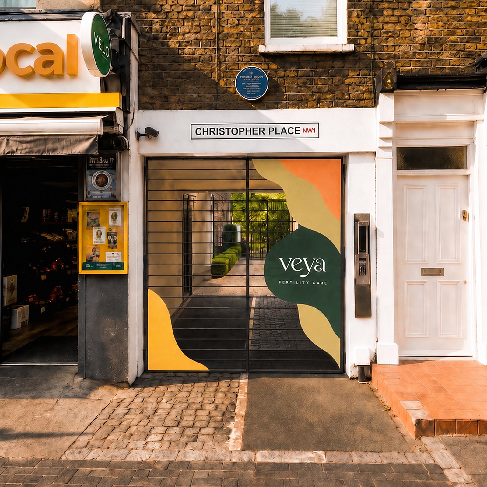 Mockup of the Veya graphics Outfly designed for the clinic’s street gates on Christopher Place, with the wordmark on a deep teal shape among sunflower and terracotta forms