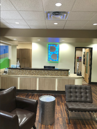 Parkway Dental lobby with front reception counter and blue illuminated accent wall