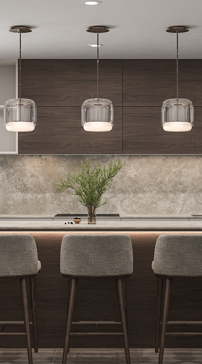 Cocina moderna con barra, tres sillas, lámparas colgantes y planta decorativa en el centro.