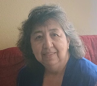 Mrs. Grace Alvarez smiling in a blue top