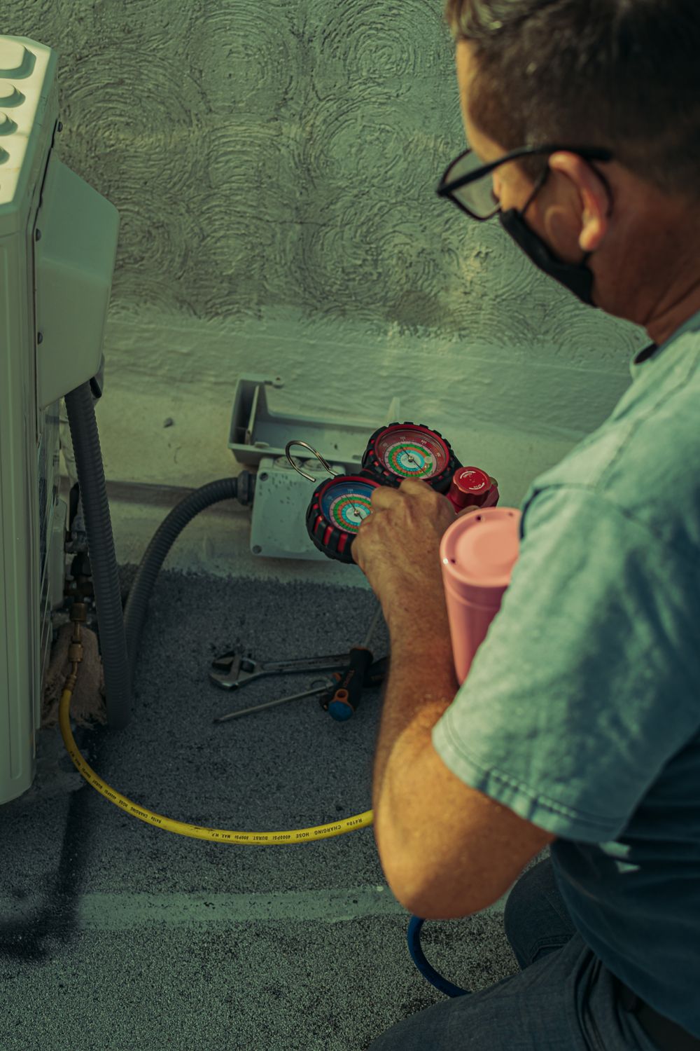HVAC technician servicing outdoor unit in North DFW