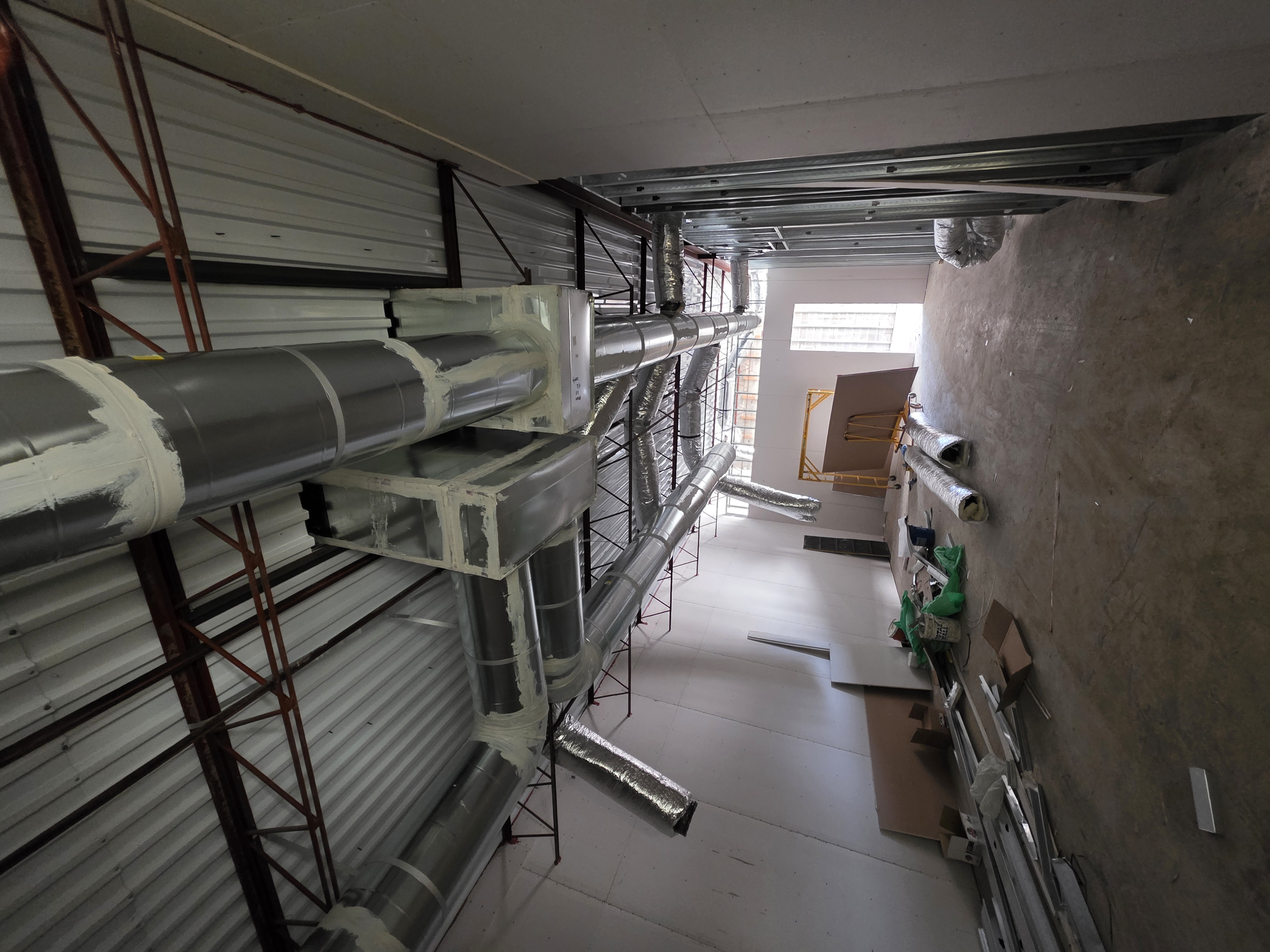 Scissor lift staged for ductwork installation
