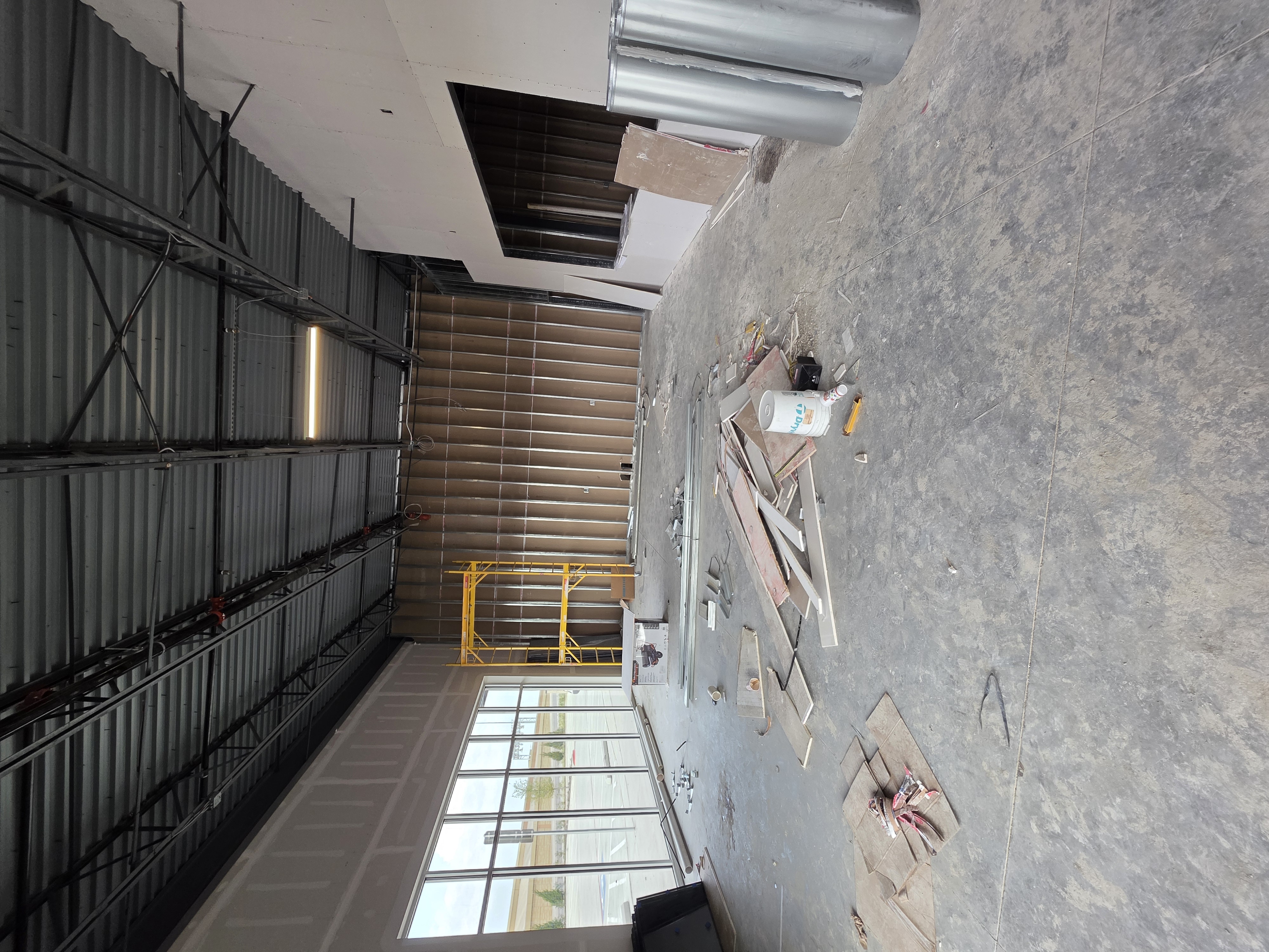 Exterior storefront construction with crane on site