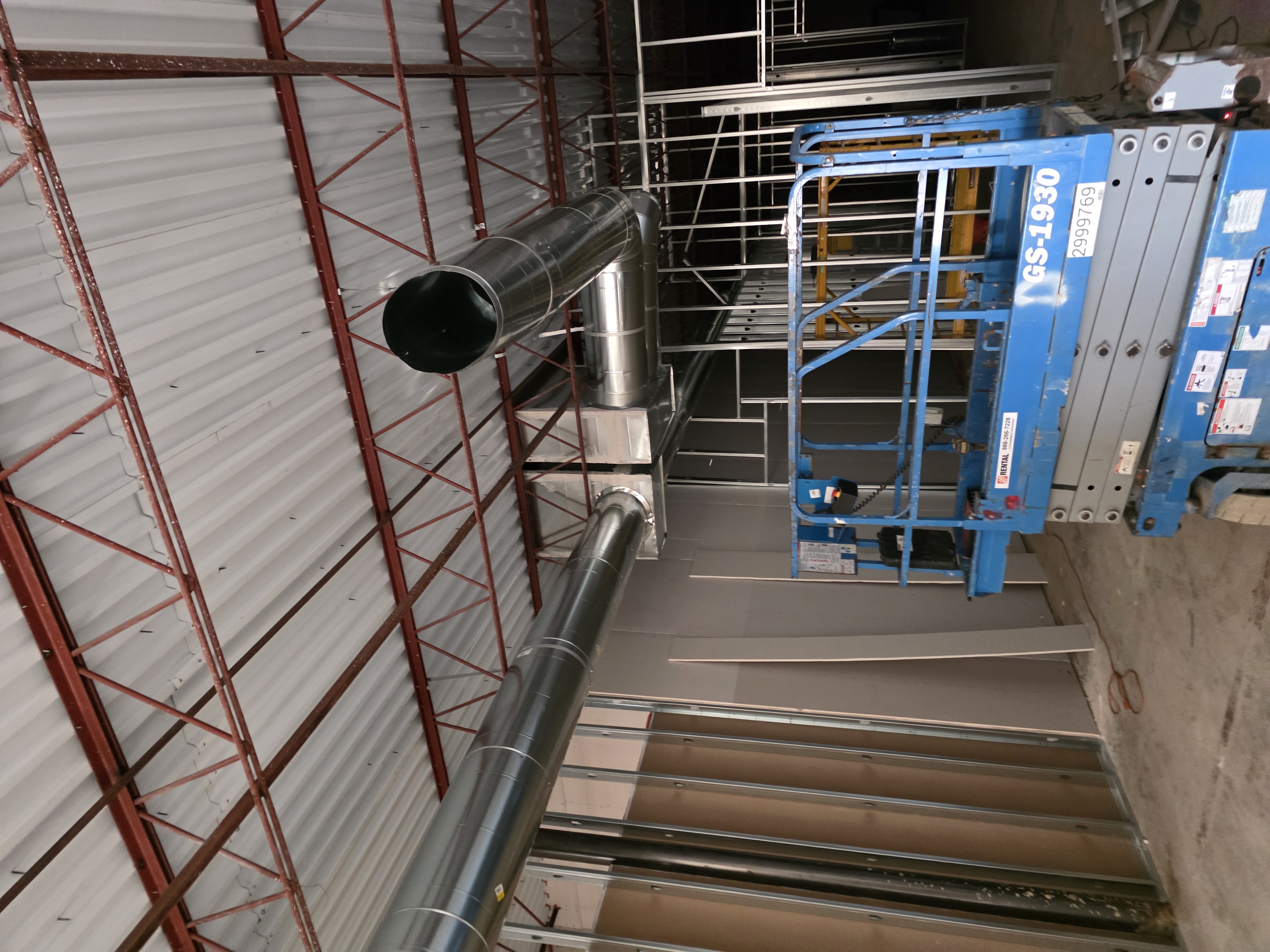 Spiral duct trunk lines run through commercial ceiling