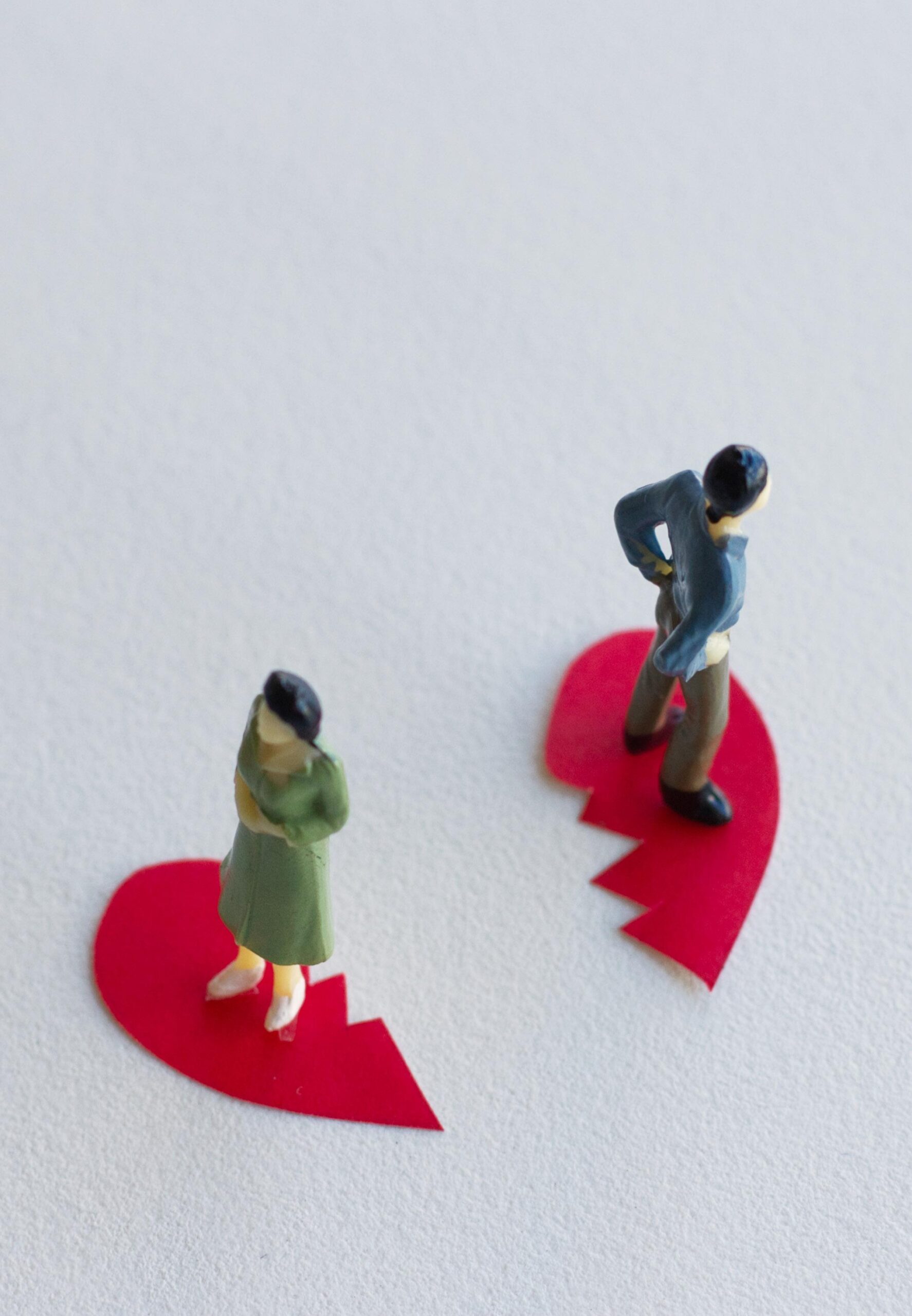 Illustration of a broken heart with a separated couple standing back to back, representing divorce