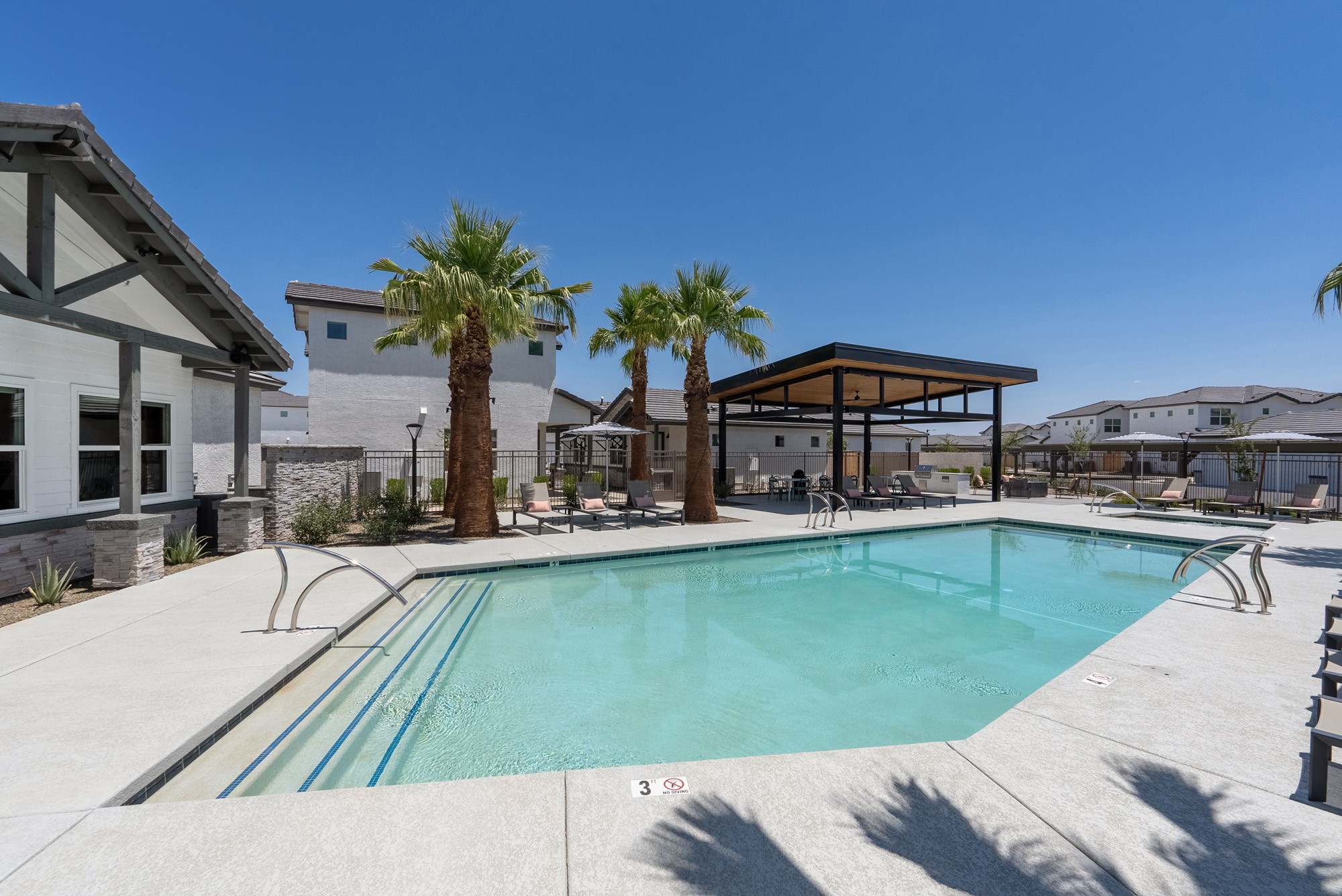 Pool with lounge chairs under cabana