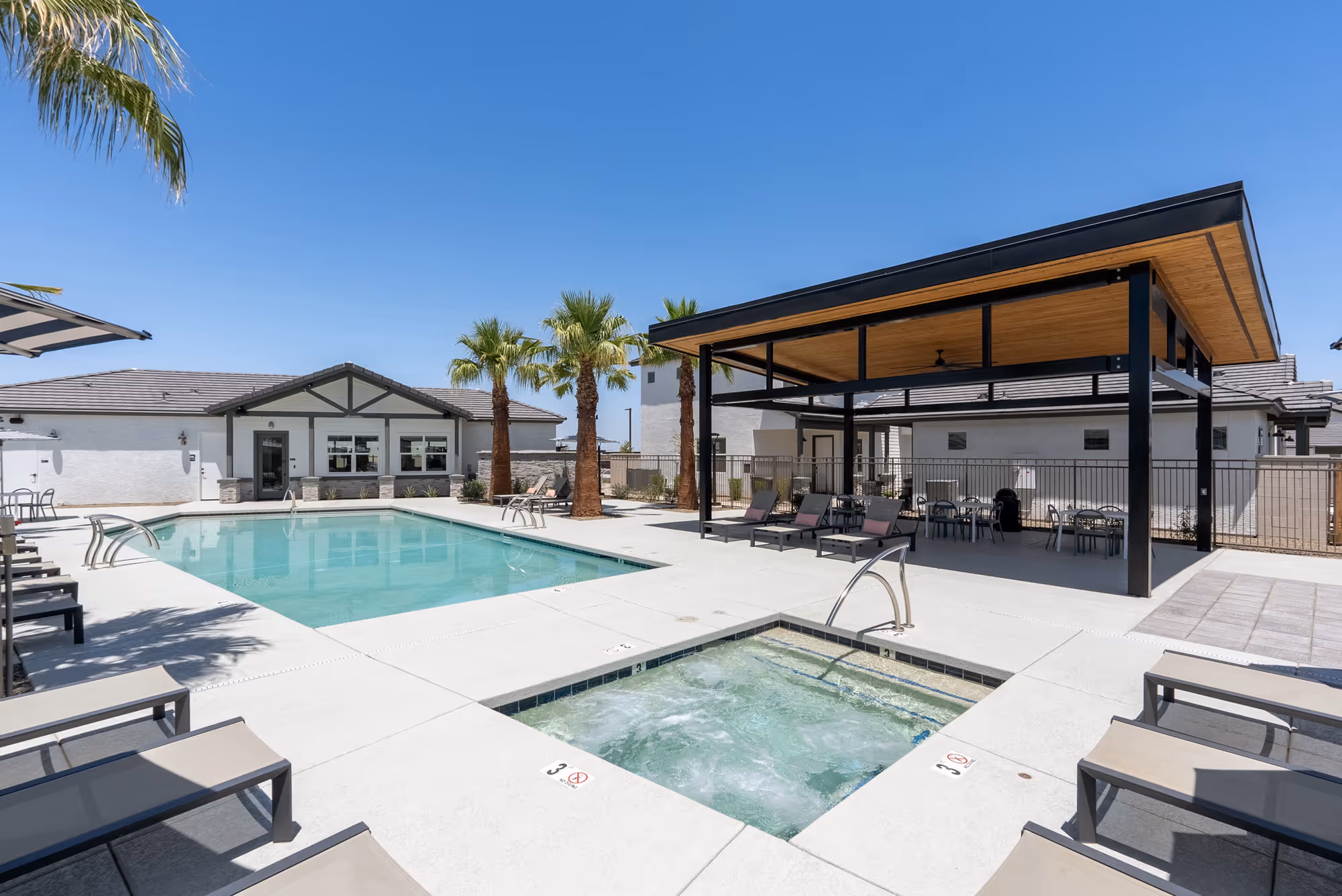 Pool wth pergola and lounge chairs