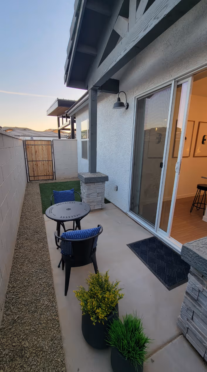 Backyard patio area with table and chairs