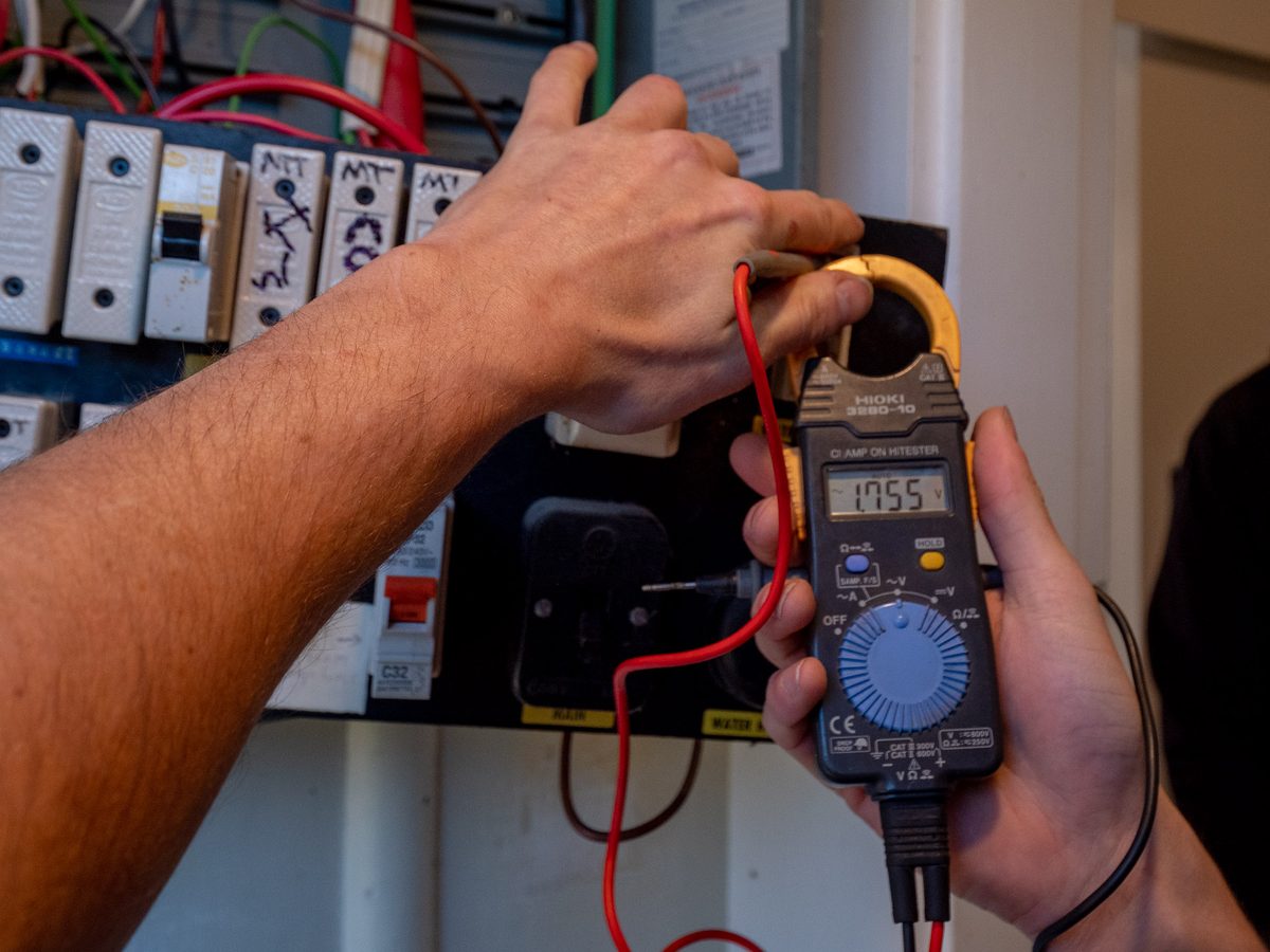 A clamp meter reading taken on a switchboard during an eCertify electrical safety check