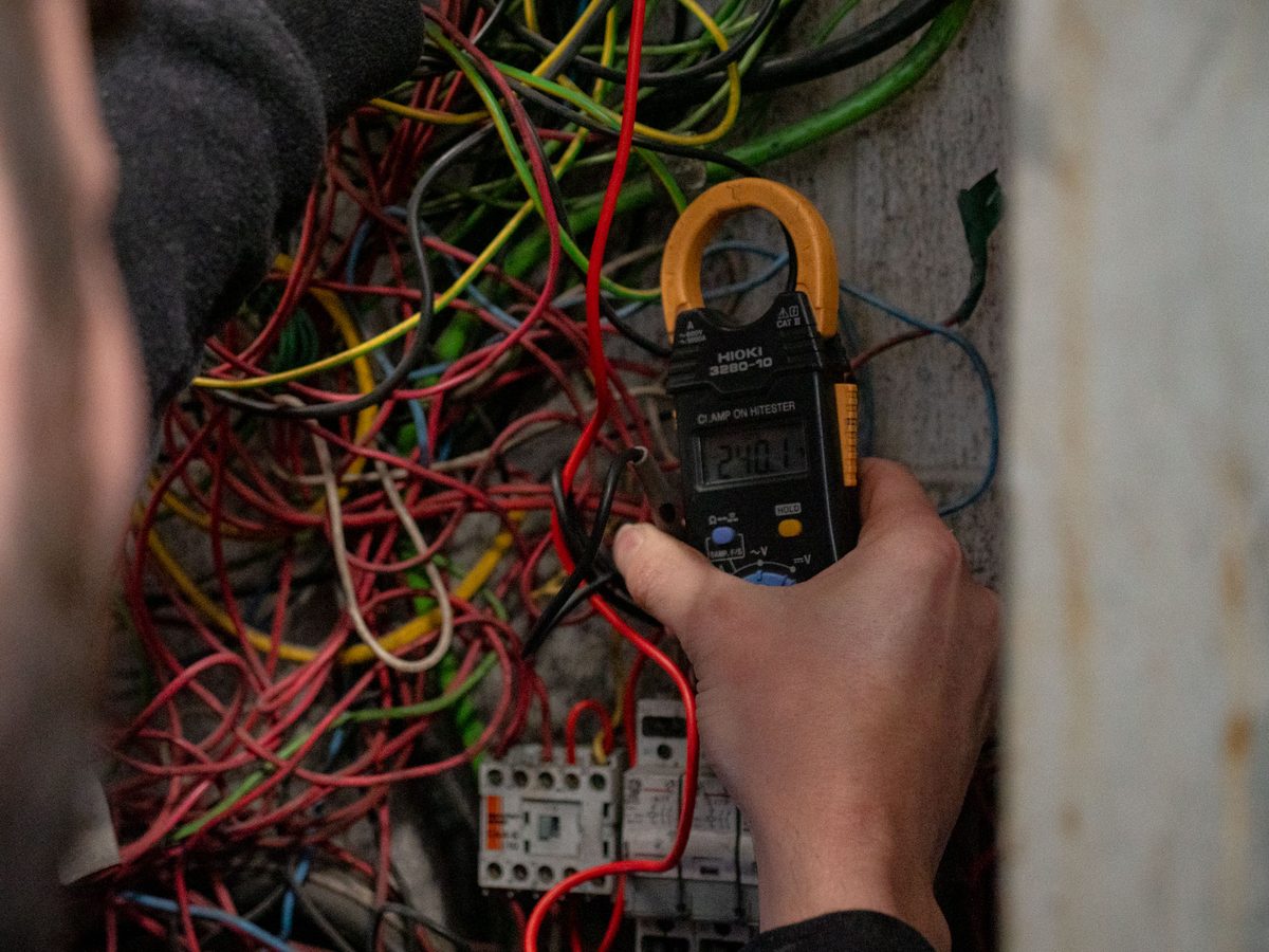 A close-up of ageing wiring under test during an eCertify rewire assessment