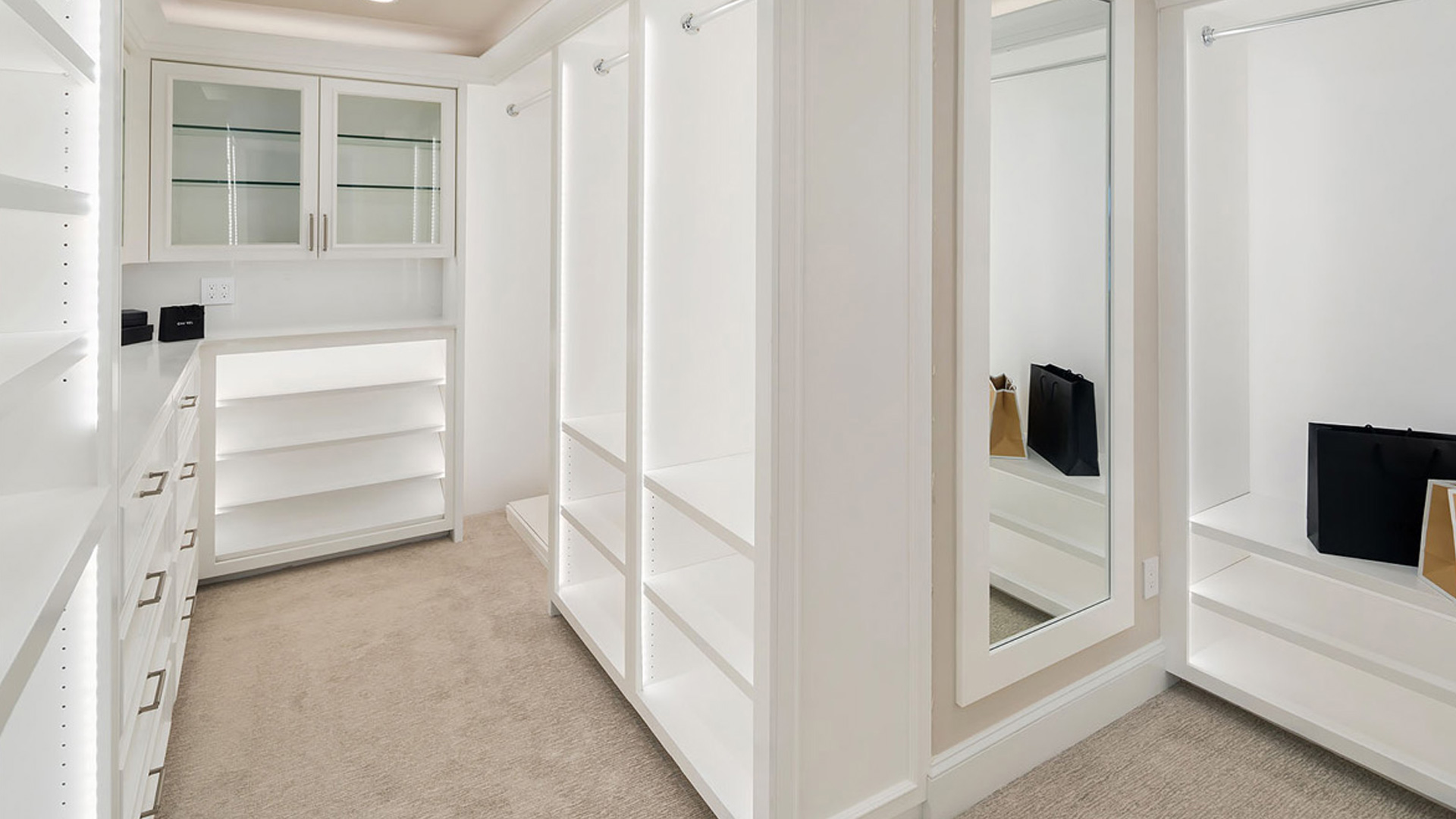 walk in closet custom designed, engineered and installed white with mirror