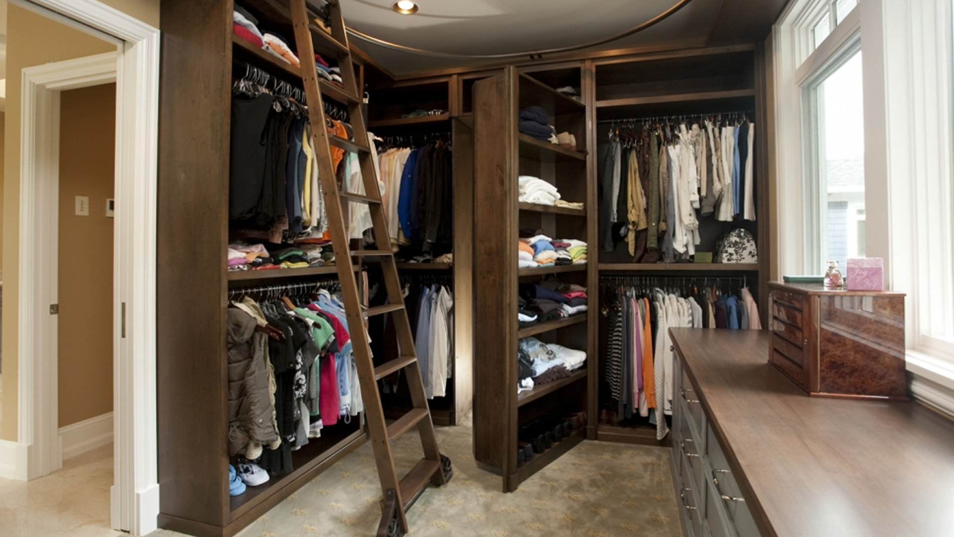 walk in closet designed, fabricated, finished and installed with clothes