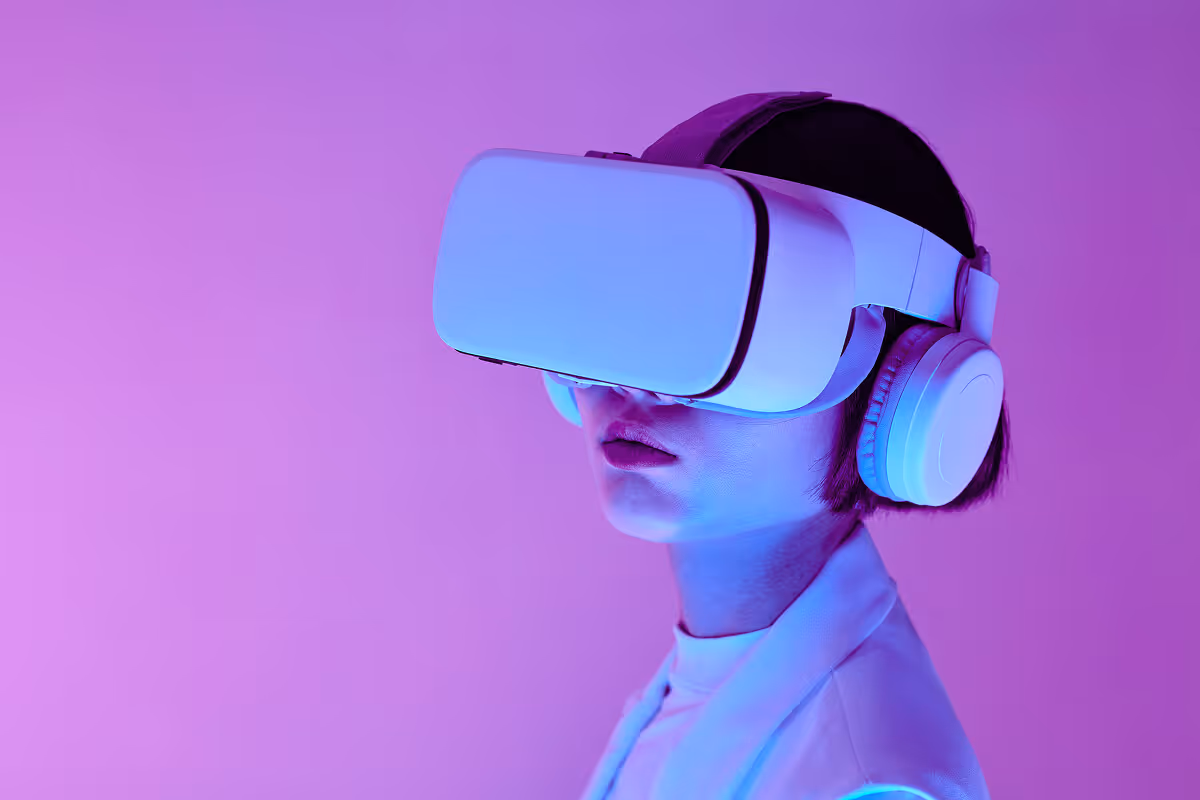 Person wearing white VR headset and headphones against a purple background.