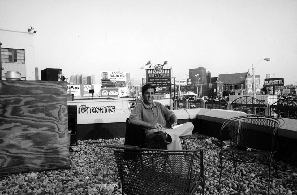 Young Bernie Smilovitz on a Detroit rooftop with Tiger Stadium and the skyline behind him, in black and white