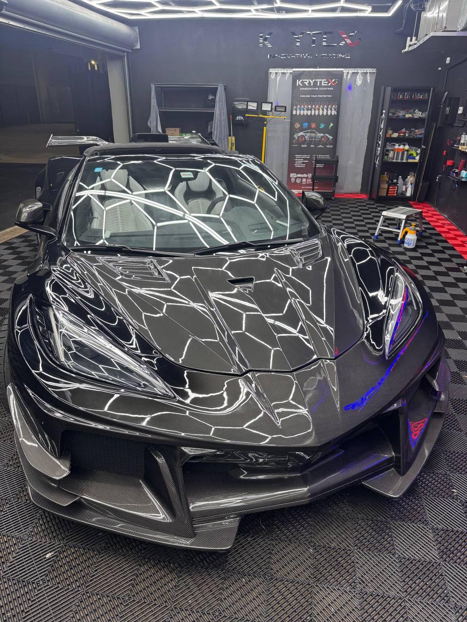 Dark green Mercedes-AMG GT in front of the vinyl color wall at Wrap Me USA Miami