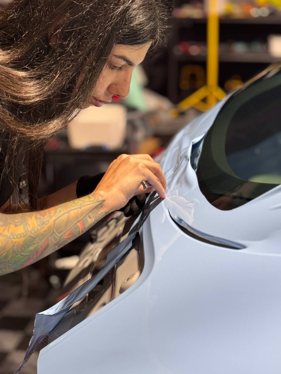 Matte black car mid-install in the Wrap Me USA Miami studio bay