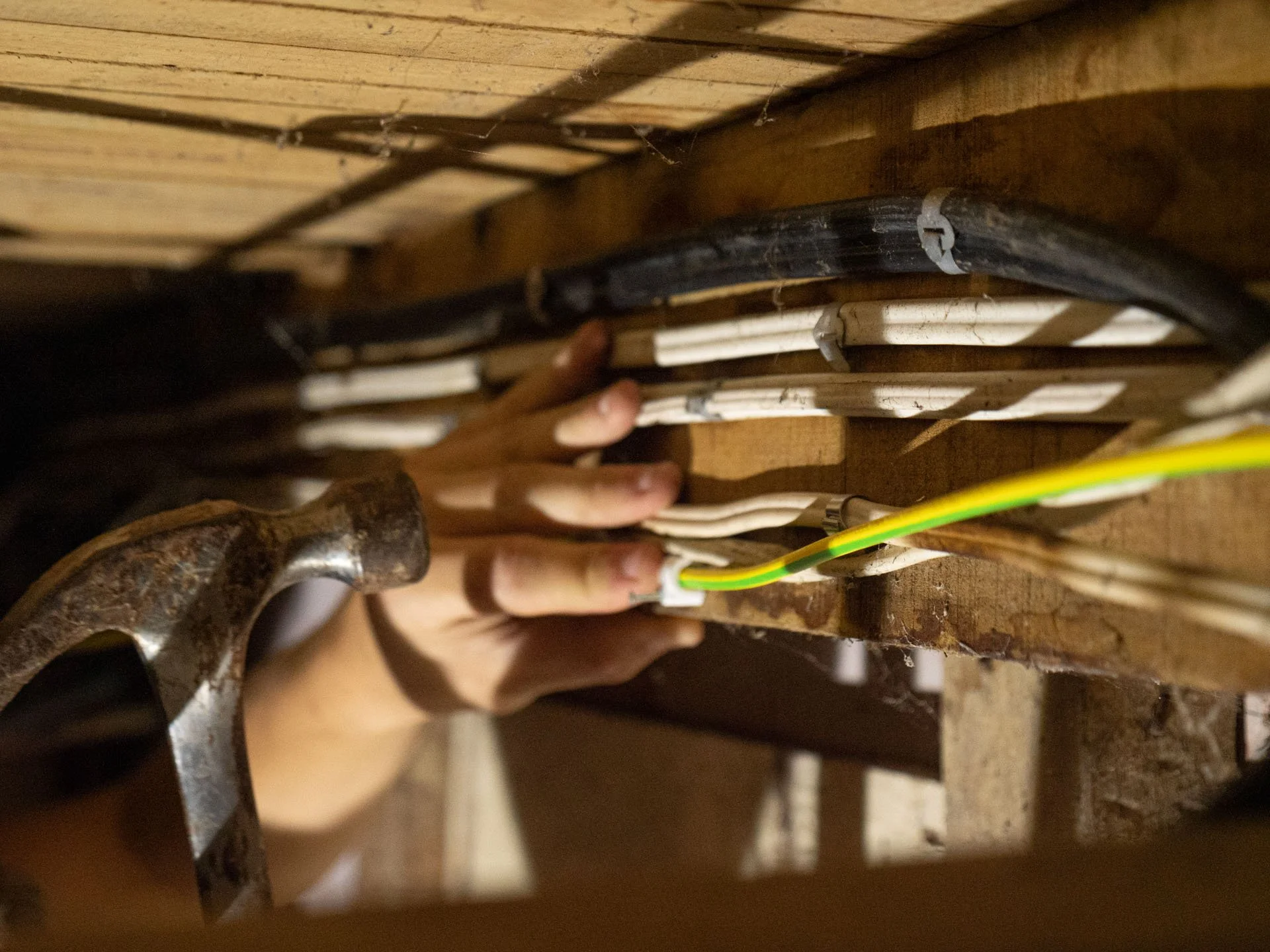 Registered inspector testing high-risk mains work at a switchboard
