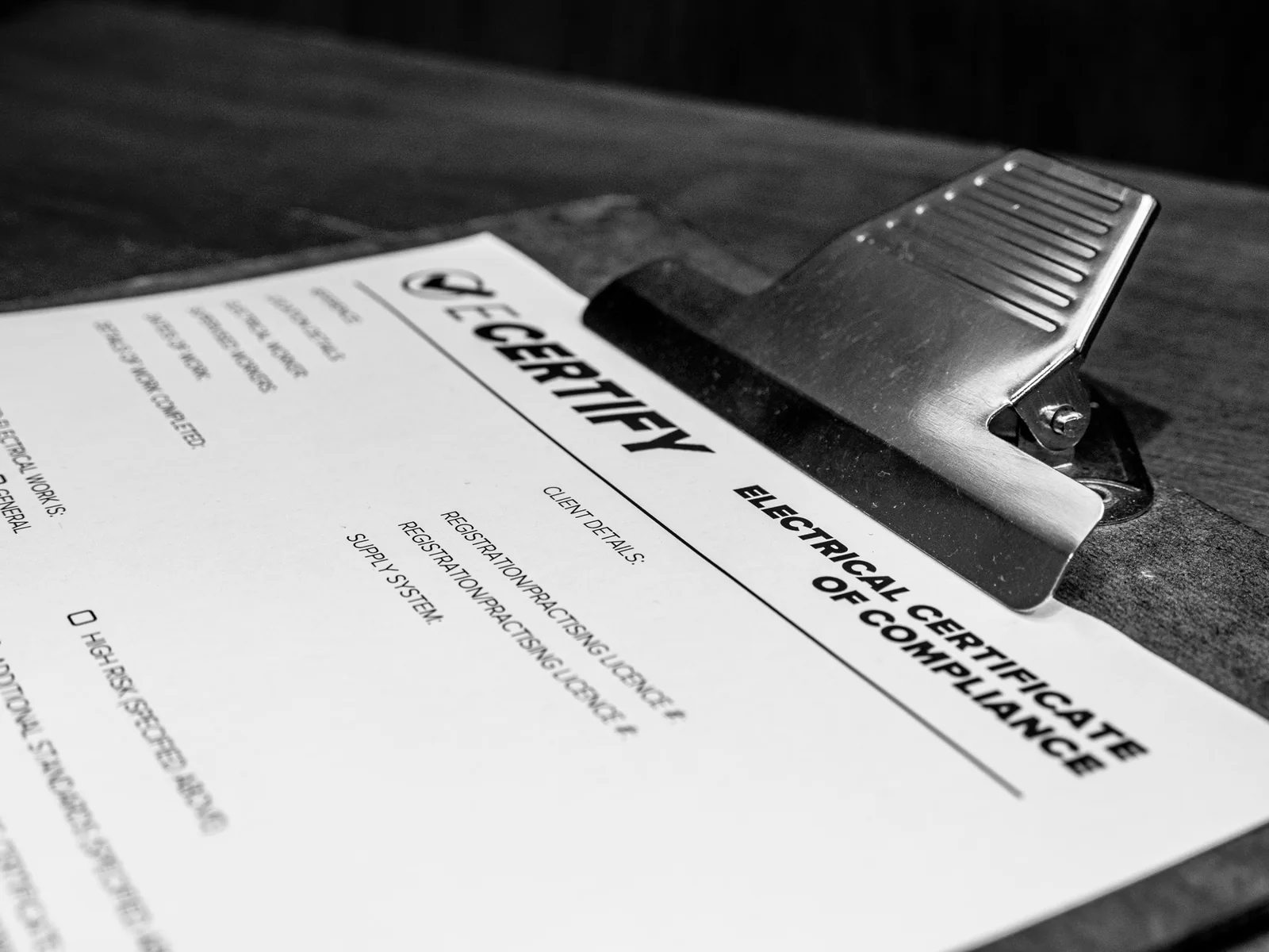 Close-up of an Electrical Certificate of Compliance on a clipboard
