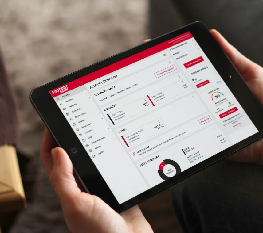 Firstrust Bank app shown on an iPhone held in hand