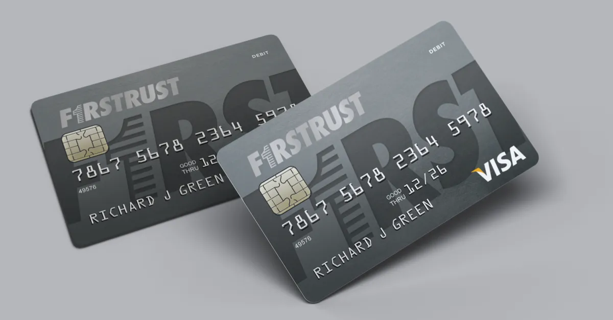 Two dark gray FirstTrust debit cards with chip and VISA logo, showing cardholder Richard J Green.