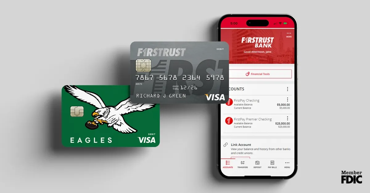 Smartphone displaying FirstTrust Bank app with account balances and two Visa debit cards, one green with eagle.