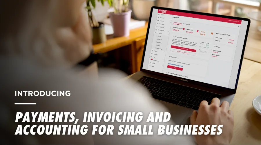 Person using laptop showing Firsturst Bank Autobooks online banking for small business payments and invoicing.