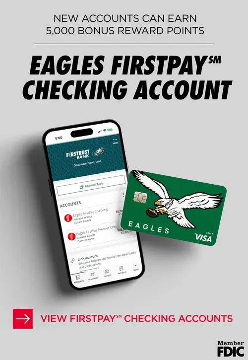 Phone displaying Furstrust Bank app with Eagles FirstPay Checking and an Eagles Visa debit card.