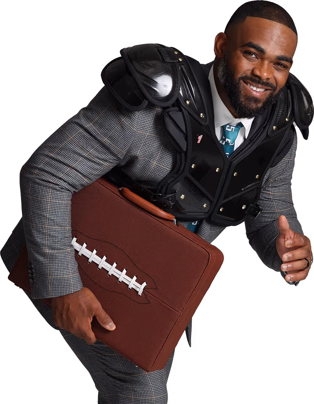 Brandon Graham in suit and football shoulder pads holding a football-shaped briefcase