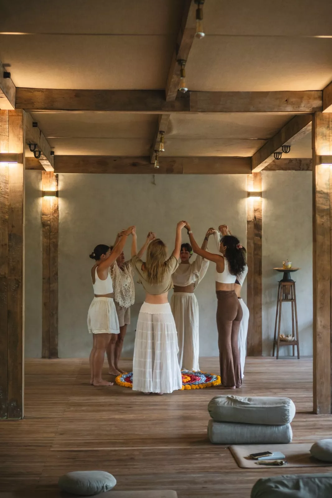 A group of women holding hands in a circle during a wellness workshop at The Shaba Shala Bali.