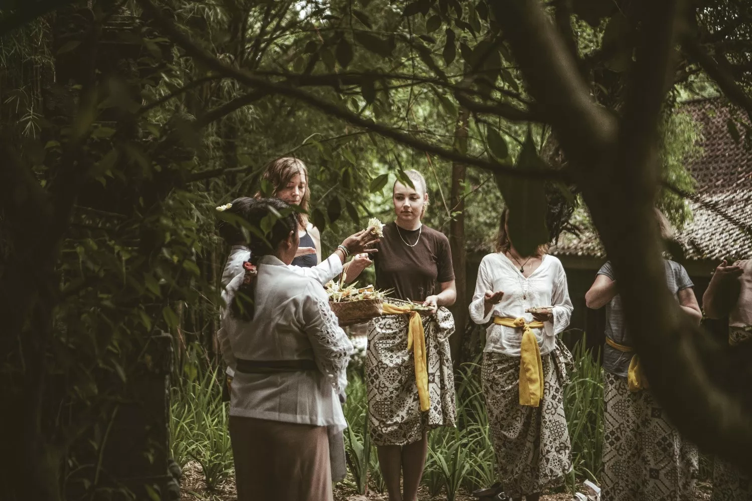 Participants taking part in a traditional Balinese cultural blessing ceremony outdoors at The Shaba Bali.