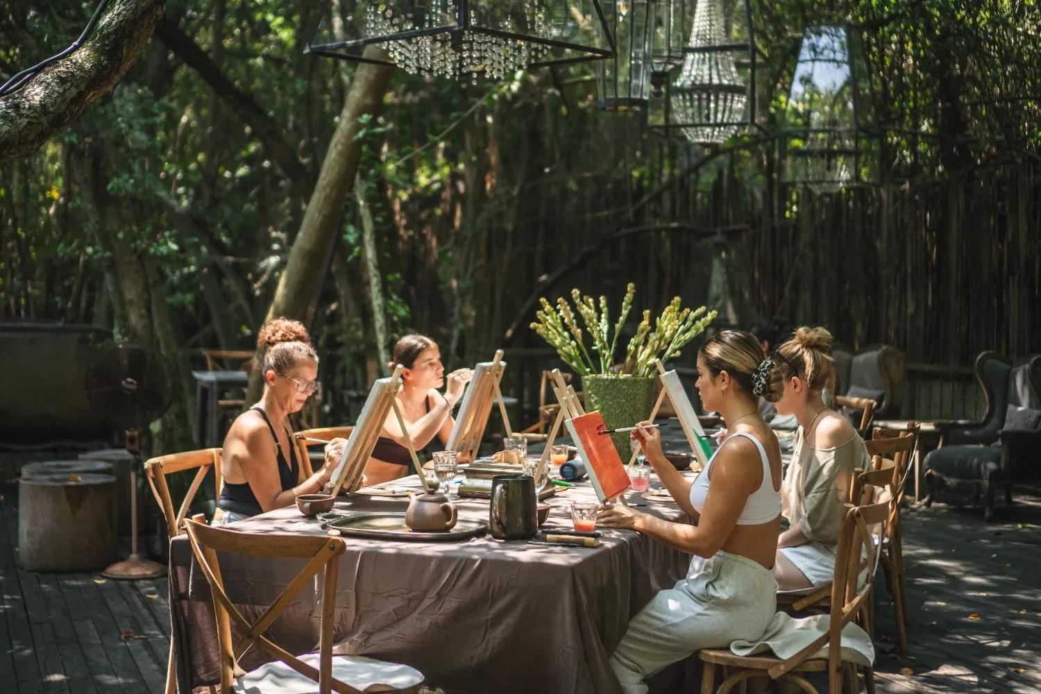 Guests painting on canvases at a long table during a creative private event workshop at The Shaba Bali.