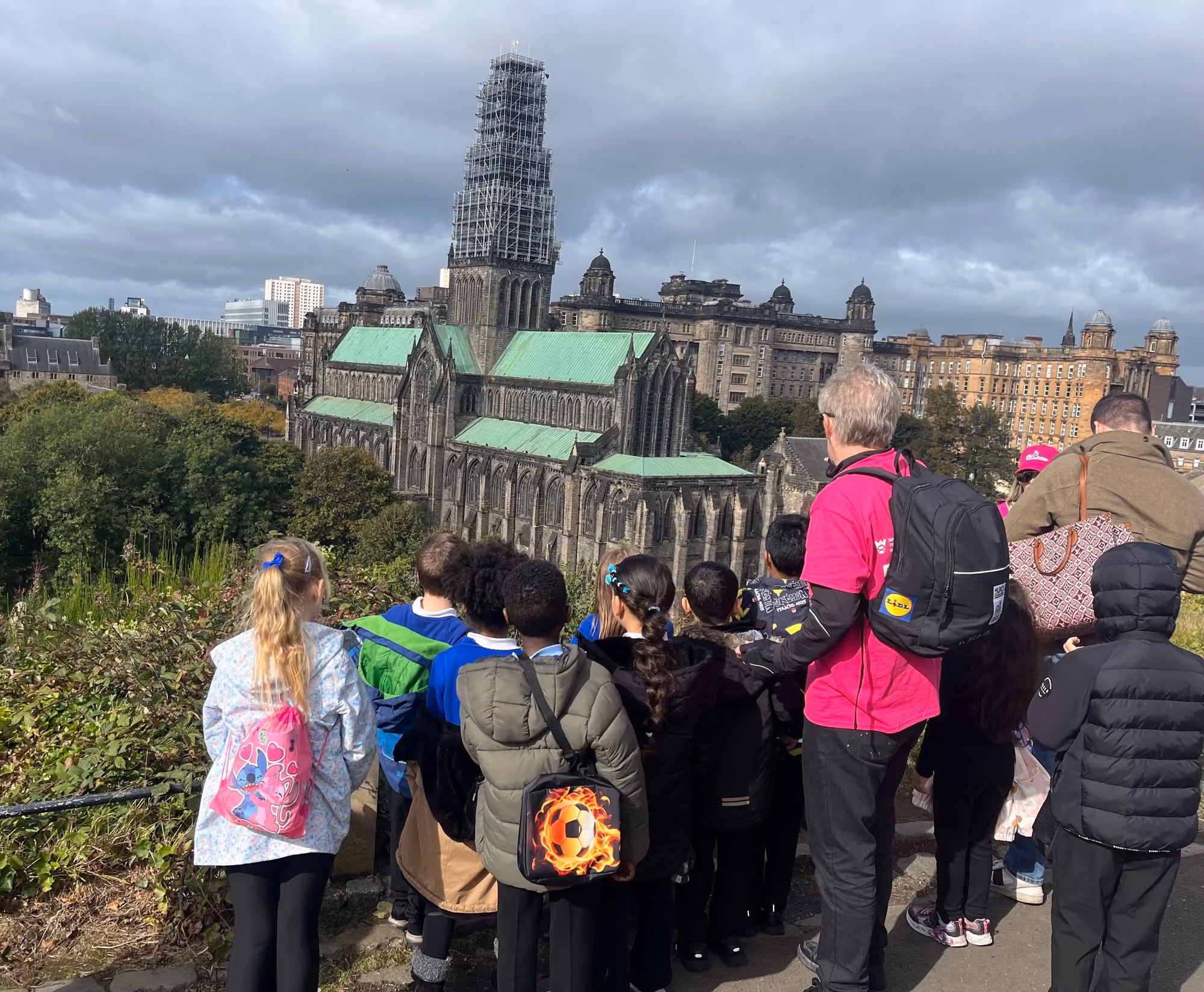 Visitors viewing Glasgow Cathedral from a hillside