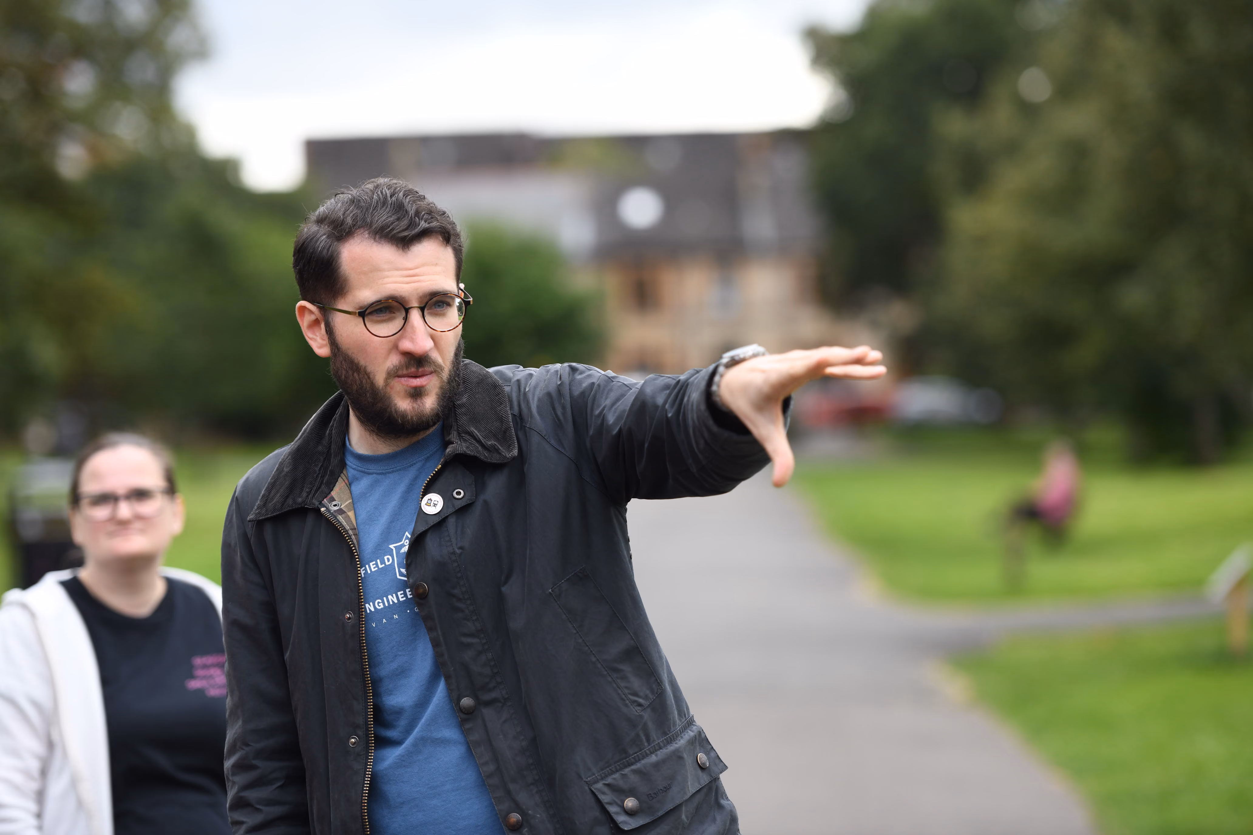 Tour guide explaining local history to visitors in a park