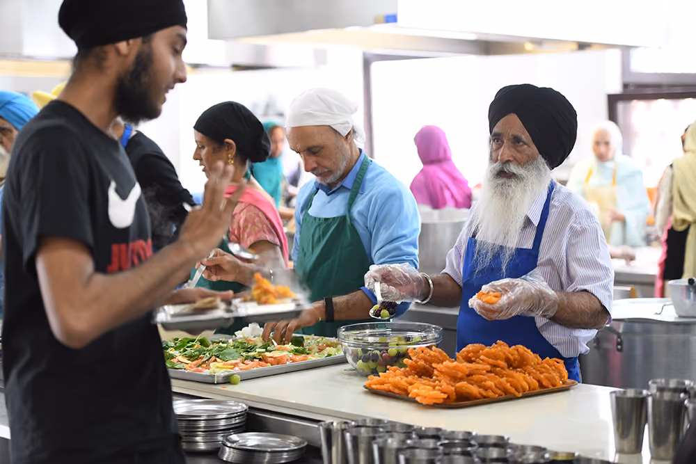 Volunteers preparing and serving food at a community event
