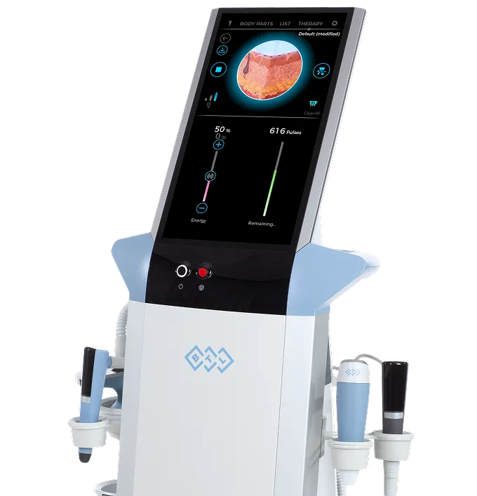 Medical device with touchscreen showing skin cross-section and pulse energy controls, with attached handheld probes.
