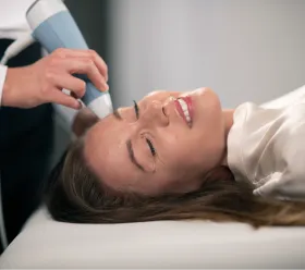 Patient mottar BTL EXION estetisk behandling med applicerare mot ansiktsomradet.