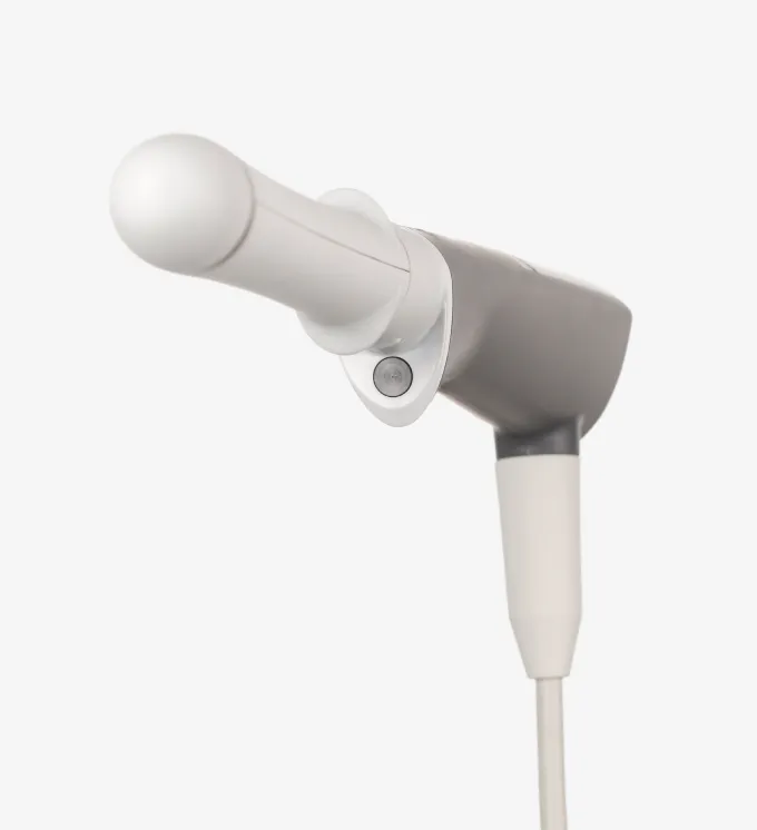 Close-up of a white and gray handheld electronic device with a cylindrical tip and cord.