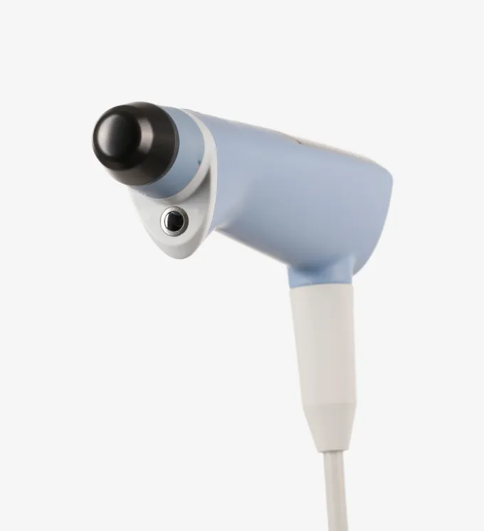Close-up of a handheld massage gun with a rounded black attachment on a white background.