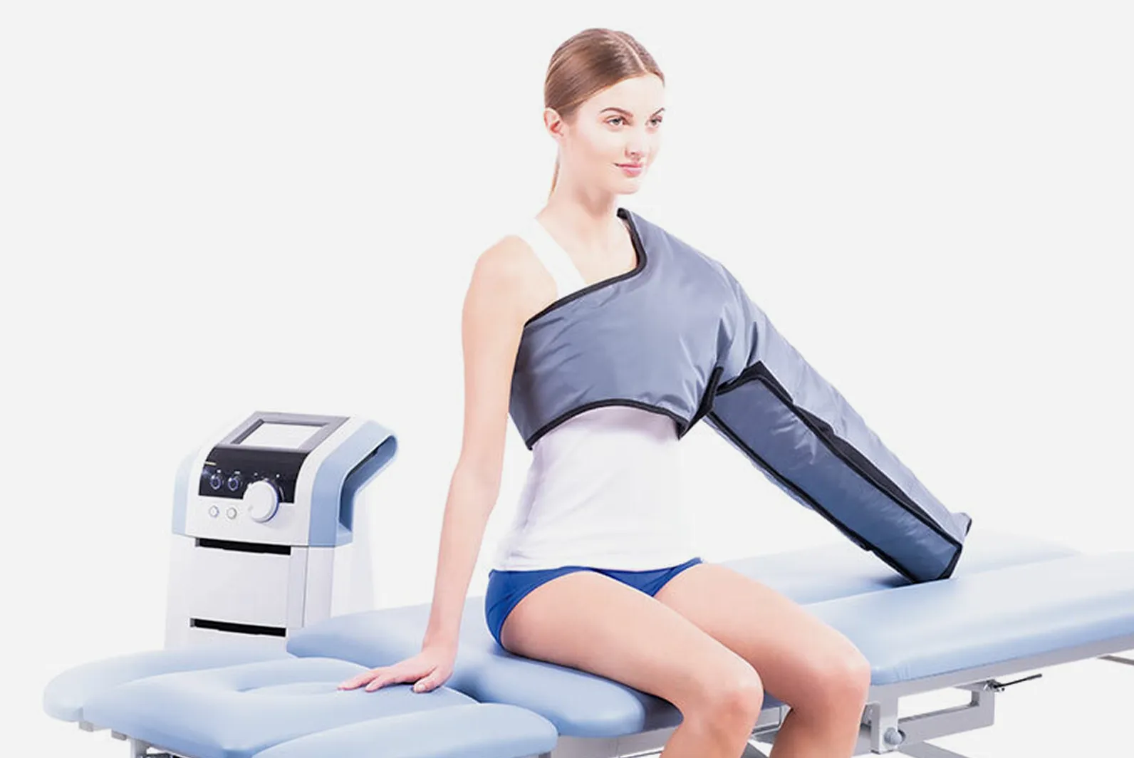 Patient som sitter under pneumatisk pressoterapibehandling med BTL Lymphastim-manschett på arm för (pressoterapi).