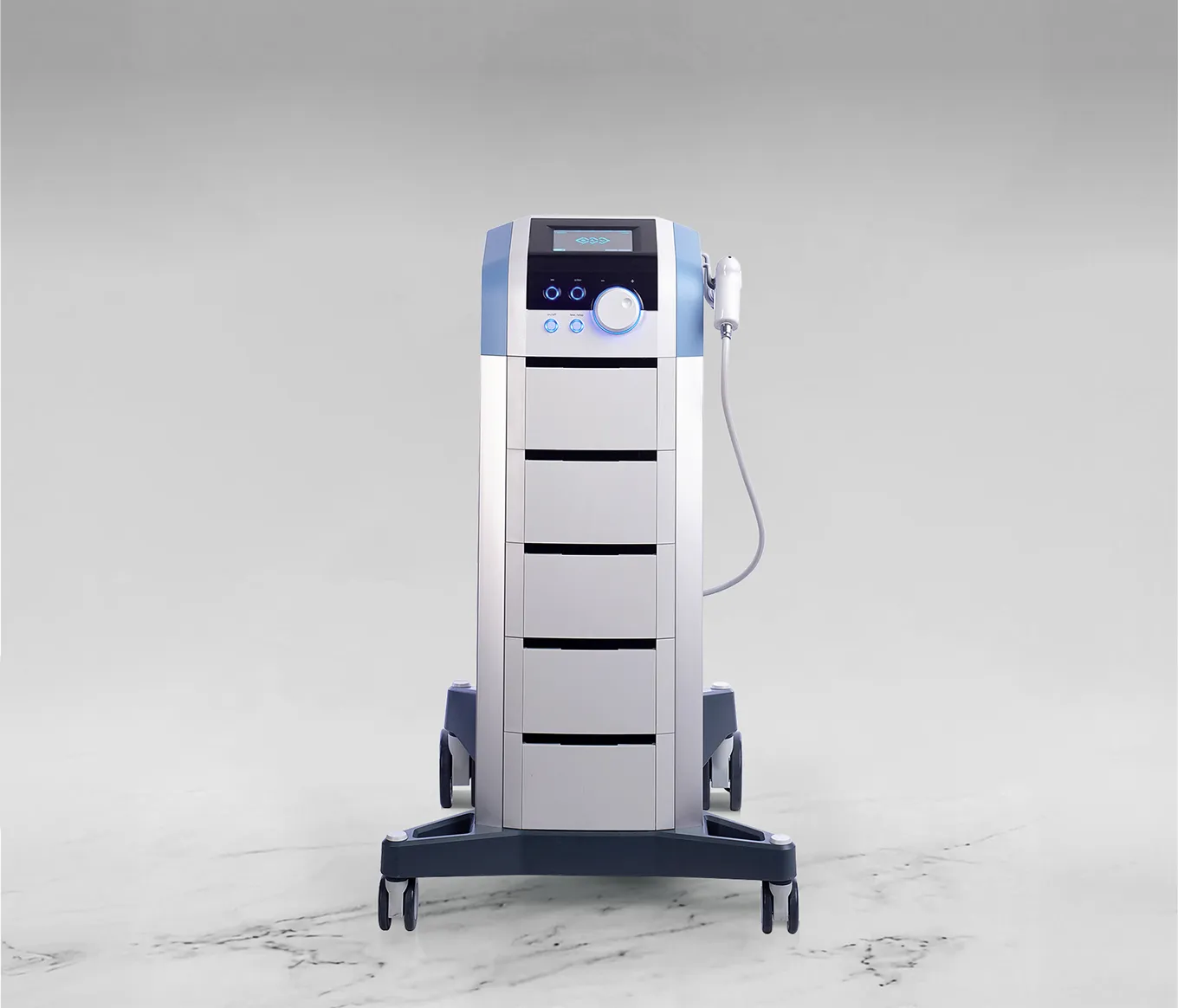 Medical device with digital display, control buttons, and handheld probe on wheels over marble floor.