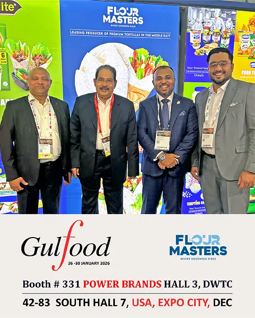 Four men in suits at Flour Masters booth promoting premium tortillas at Gulfood 2026 event.